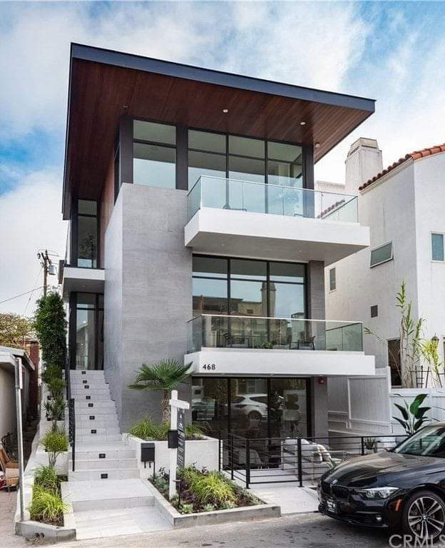 Modern white and grey villa with glass balconies